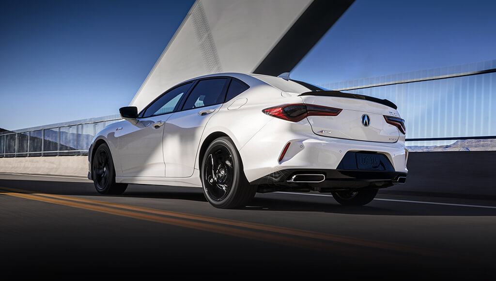2023 White Acura TLX Sedan Rear and Side View Driving on Road