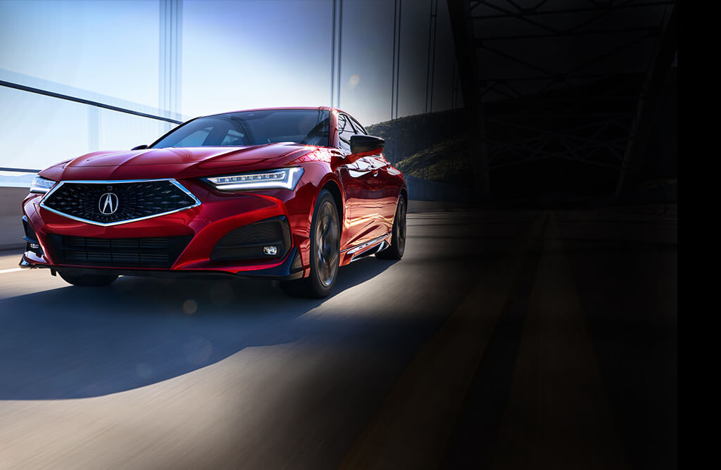 2023 Red Acura TLX Sedan Front and Side Profile Driving on Road